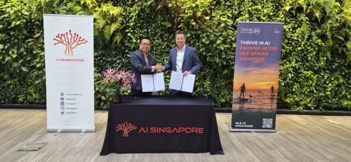 Representatives from AI Singapore and Digital Isle of Man standing skating hands after signing of a Memorandum of Understanding (MOU) Agreement